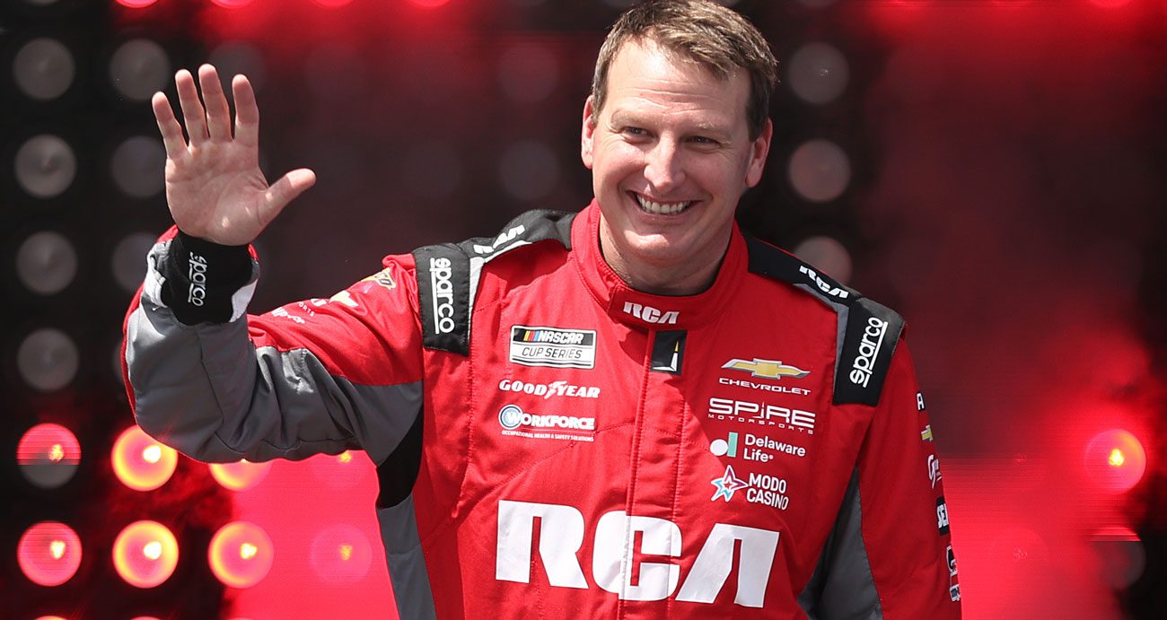 Michael McDowell waves to the crowd before a NASCAR Cup Series race.
