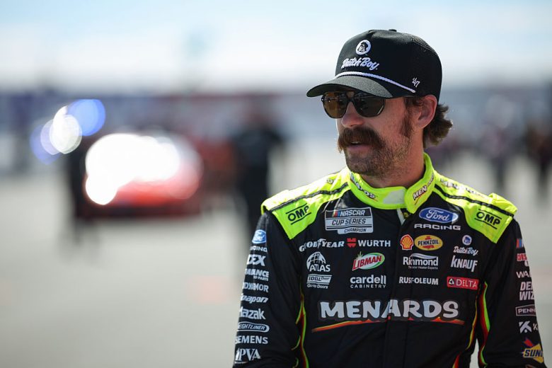 Ryan Blaney looks on.