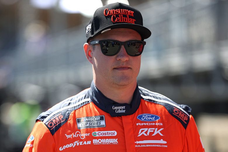 Ryan Preece looks on.