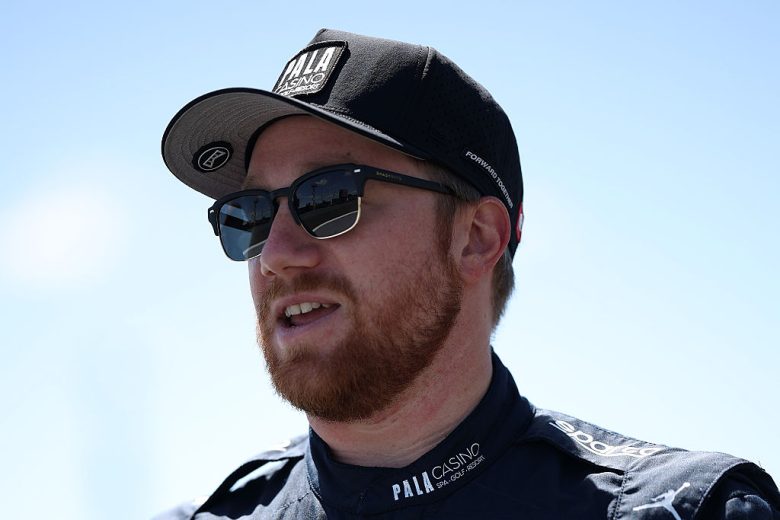 Tyler Reddick looks on.