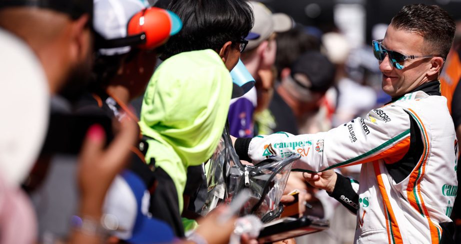 AJ Allmendinger signs autographs.