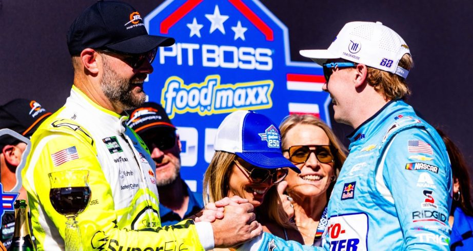 Connor Zilisch shakes hands with Shane van Gisbergen in Victory Lane.