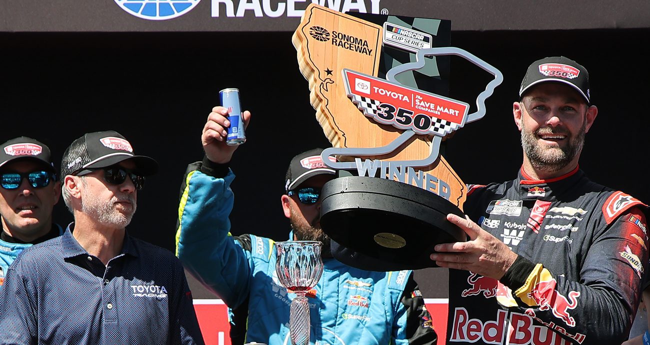 Shane van Gisbergen hoists the trophy after winning the NASCAR Cup Series race on June 28, 2026 at Sonoma Raceway.