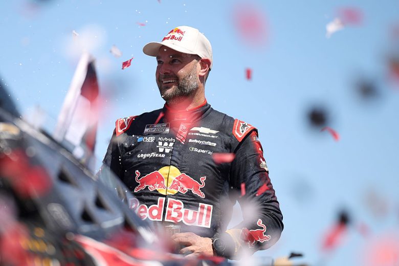 Shane van Gisbergen looks on as confetti falls.