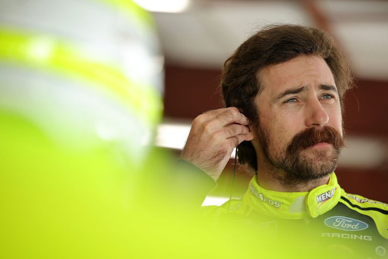 Ryan Blaney looks on.