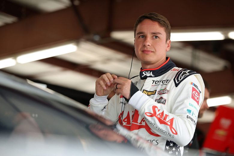 Christopher Bell looks on.