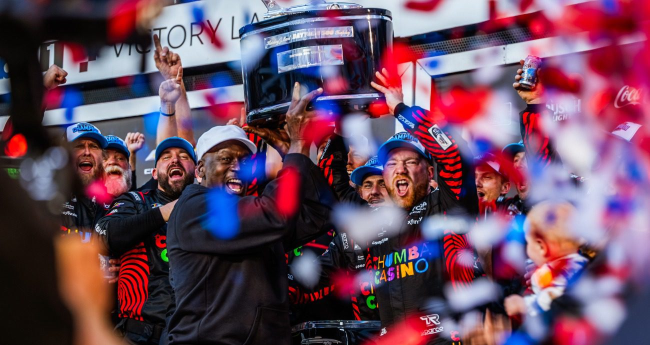 Tyler Reddick and Michael Jordan hold up Harley J. Earl trophy at Daytona.