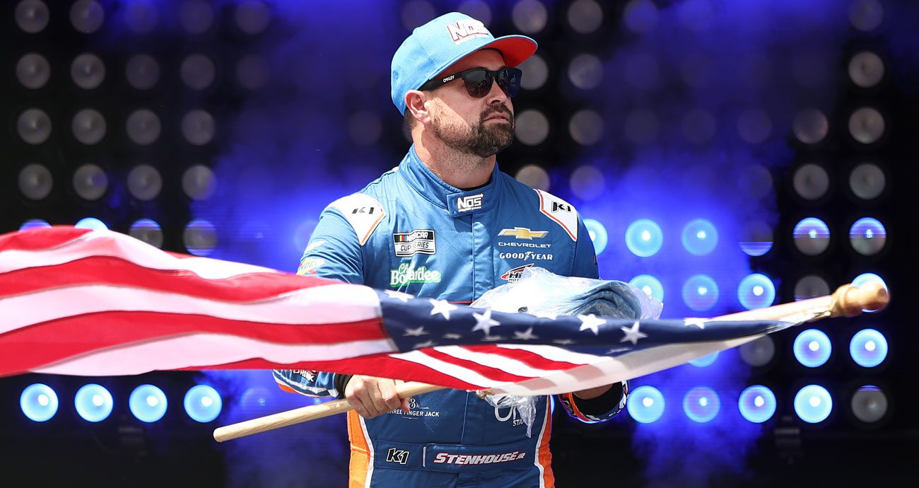 Ricky Stenhouse Jr. waves a United States flag at Dover Motor Speedway.