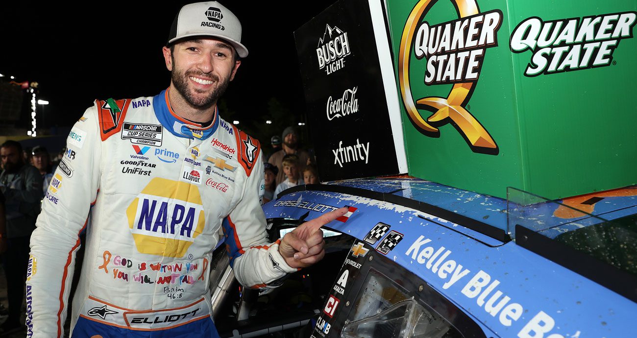 Chase Elliott poses for a photo in Victory Lane at EchoPark Speedway.