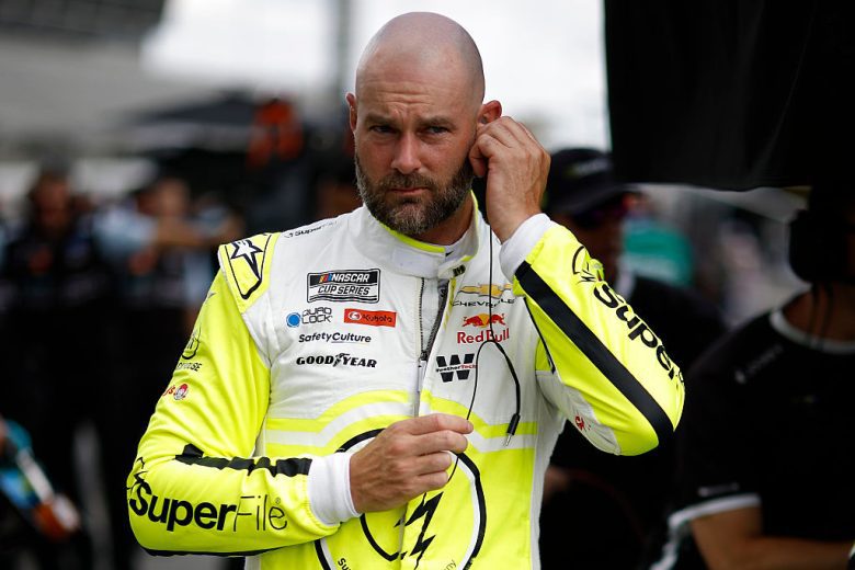 Shane van Gisbergen looks on.