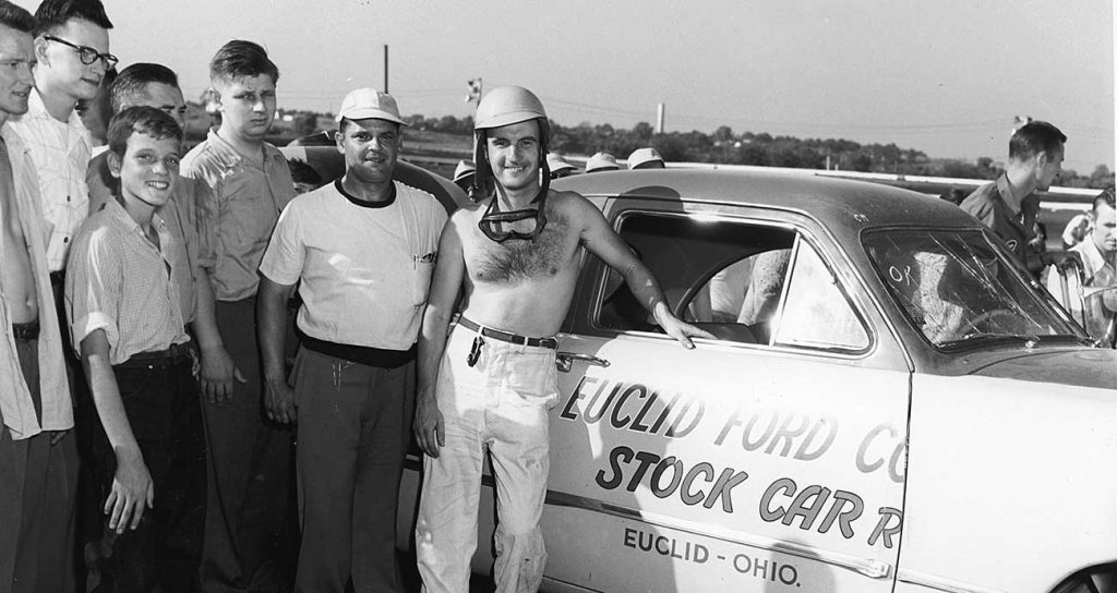 A shirtless Jimmy Florian poses with his race-winning Ford at Dayton Speedway in June 1950