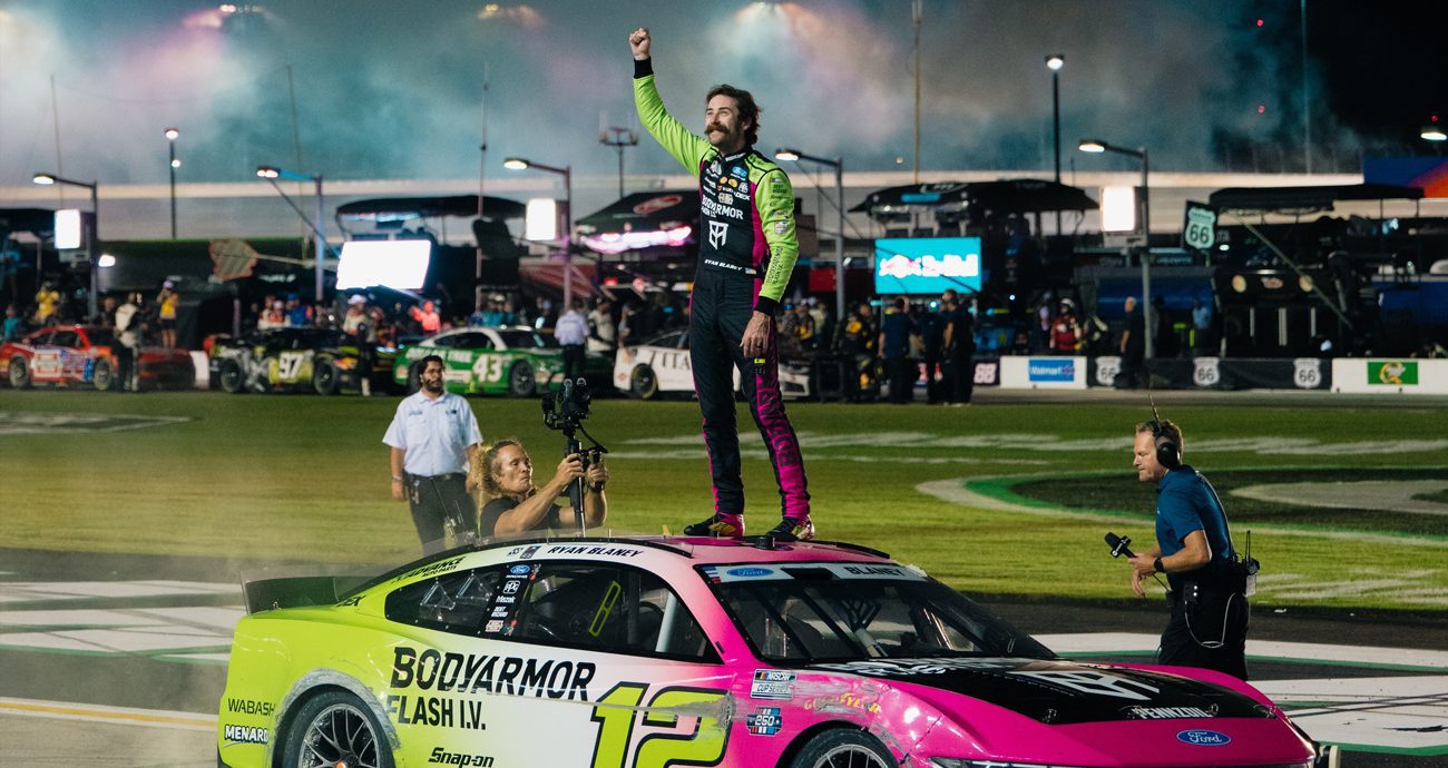 Ryan Blaney celebrates atop his car after winning at EchoPark Speedway