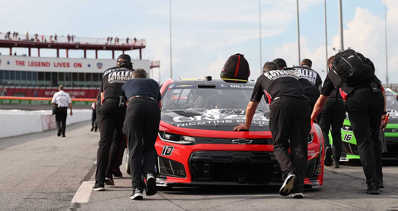 The Kaulig Racing crew pushes Ty Dillon's No. 10 Chevy to the practice grid at North Wilkesboro Speedway