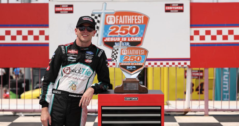 Chandler Smith poses next to Craftsman Truck Series trophy at North Wilkesboro Speedway.