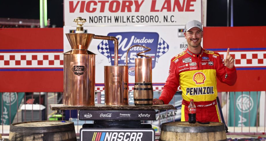 Joey Logano poses for a photo in Victory Lane at North Wilkesboro Speedway.