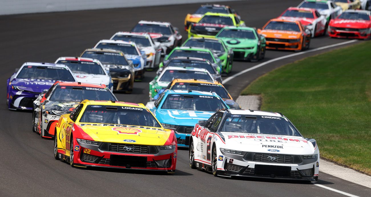 NASCAR Cup Series cars race at Indianapolis Motor Speedway.