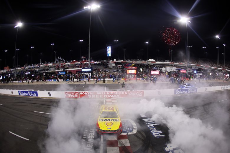 Joey Logano does a burnout in the No. 22 Ford.