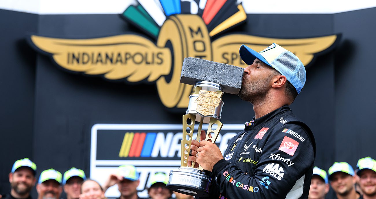 bubba wallace kisses trophy in victory lane