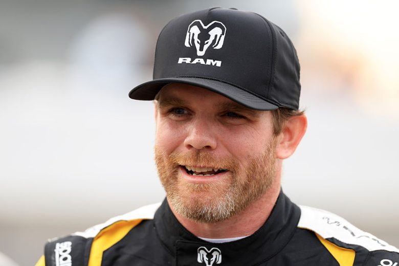 Conor Daly looks on.