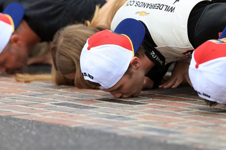 Carson Kvapil kisses the bricks.
