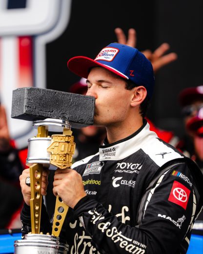 Corey Heim kisses the victory trophy.