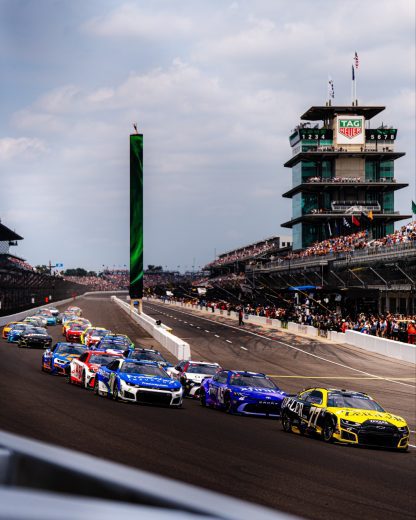 NASCAR Cup Series cars race at Indianapolis Motor Speedway.