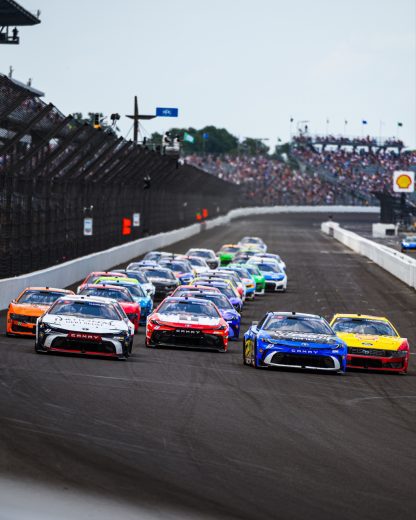 NASCAR Cup Series cars race at Indianapolis Motor Speedway.