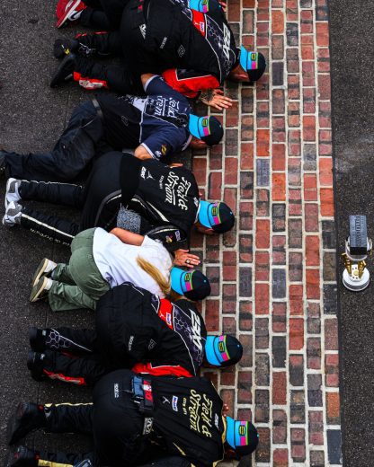 Corey Heim and his No. 67 team kiss the bricks.