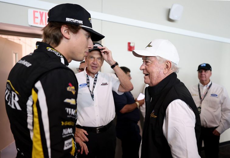 Carson Hocevar (L) speaks with Roger Penske (R).