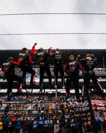 Corey Heim's No. 67 team climbs the fence.