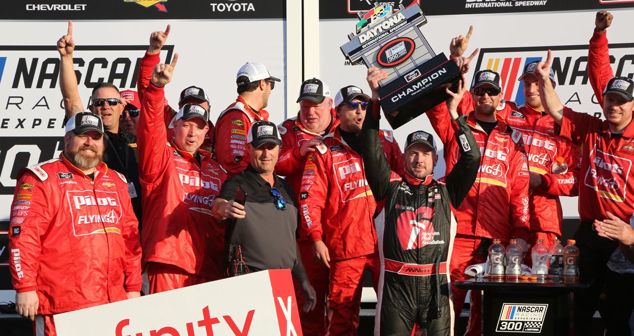 Michael Annett celebrates with us No. 1 NASCAR O'Reilly Auto Parts Series team in Victory Lane at Daytona International Speedway.