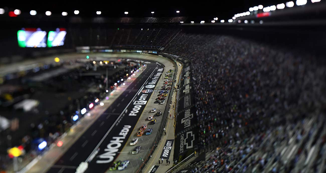 The NASCAR Cup Series field roars down the frontstretch during the annual Bass Pro Shops Night Race at Bristol Motor Speedway