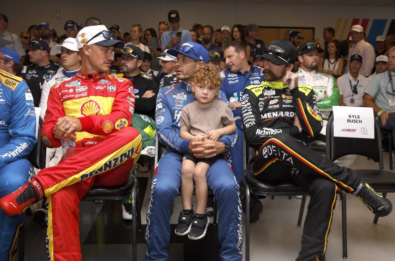 Joey Logano talks with Kyle Larson and Ryan Blaney.