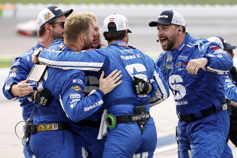 The pit crew celebrates on pit road.