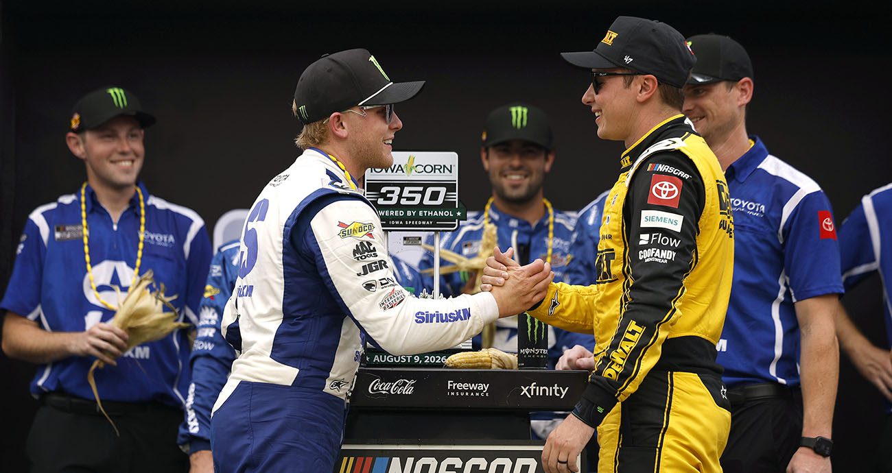 Ty Gibbs and Christopher Bell shake hands in Victory Lane at Iowa after Gibbs won a NASCAR Cup Series race.