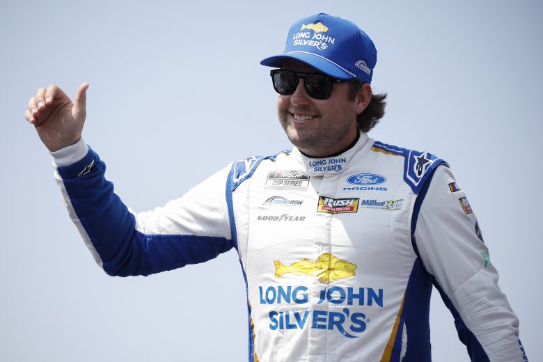 Noah Gragson, driver of the No. 4 Long John Silver's Ford, waves to fans as he walks onstage during driver intros before the NASCAR Cup Series Iowa Corn 350 Powered by Ethanol at Iowa Speedway on Aug. 9, 2026 in Newton, Iowa.