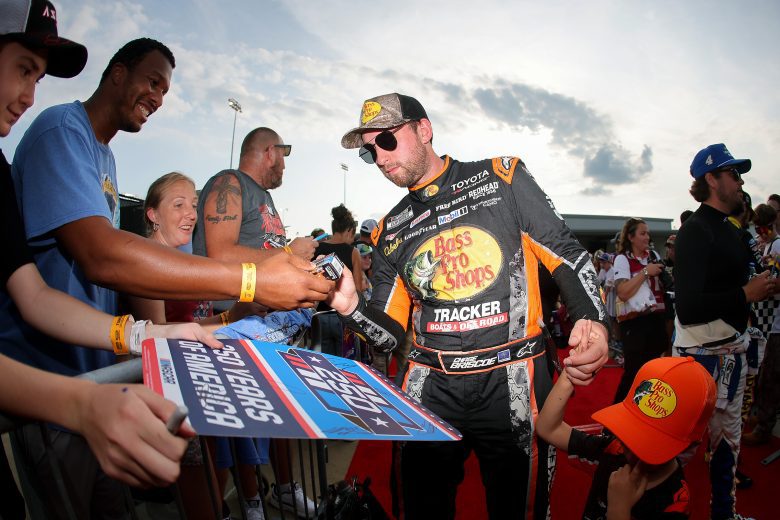 Chase Briscoe signs autographs for fans on the red carpet at Richmond.