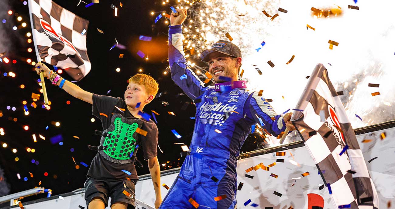 Kyle Larson celebrating with Owen in Victory Lane after winning the Knoxville Nationals
