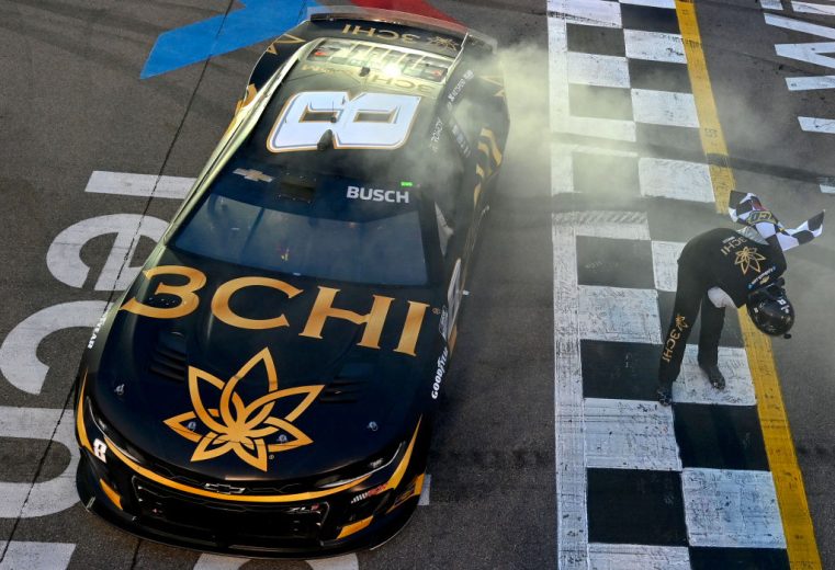 Kyle Busch does a celebratory bow next to his No. 8 Chevrolet at World Wide Technology Raceway at Gateway.