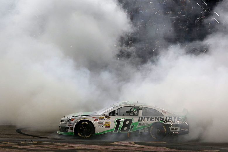 A view of the No. 18 Joe Gibbs Racing Toyota doing a celebratory burnout at Texas Motor Speedway.