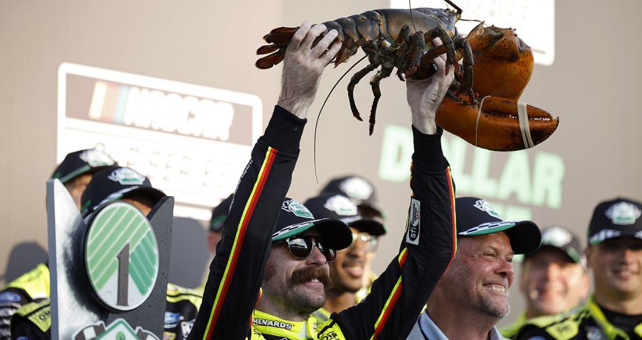 Ryan Blaney hoists a lobster in Victory Lane.