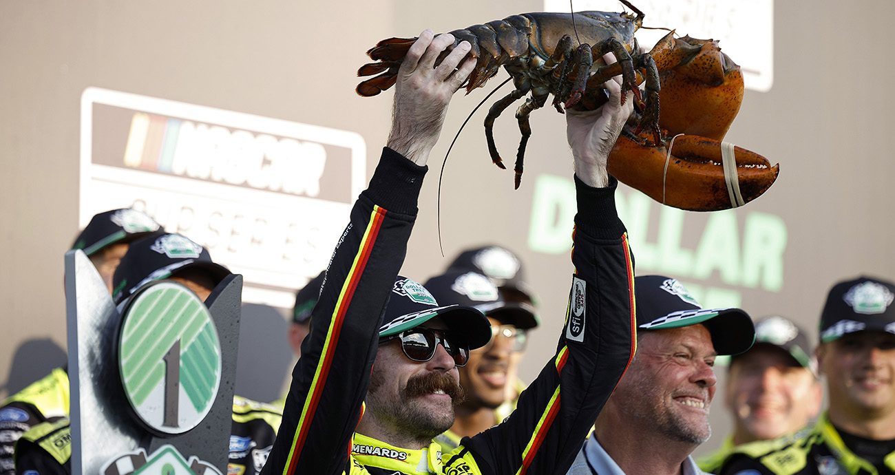 Ryan Blaney hoists a lobster in Victory Lane.