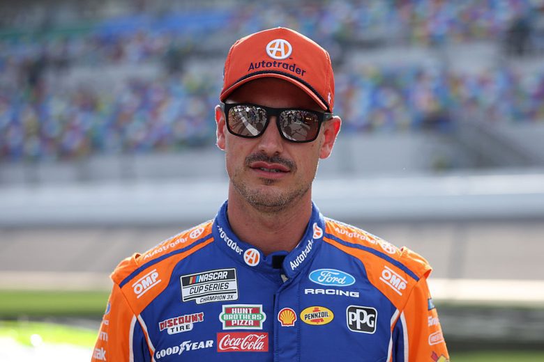 Joey Logano looks on.