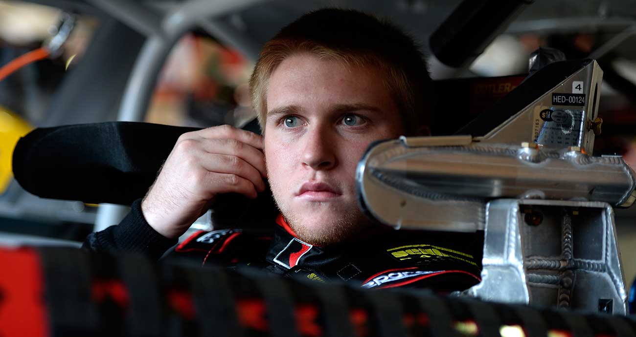 Chris Buescher suits up in the garage area at Auto Club Speedway