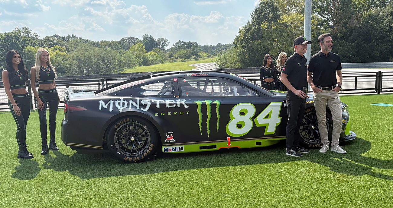 riley herbst and jimmie johnson pose by the No. 84 Toyota