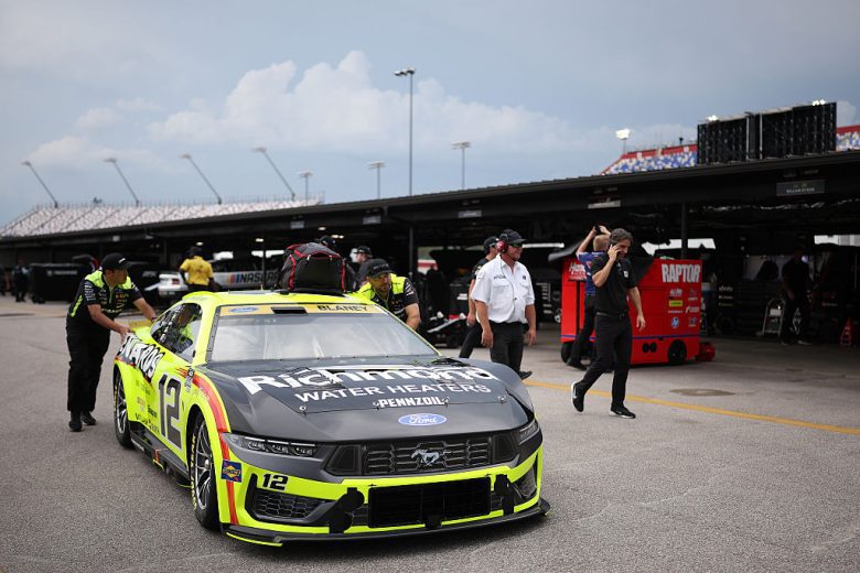 Ryan Blaney's crew pushes his car.