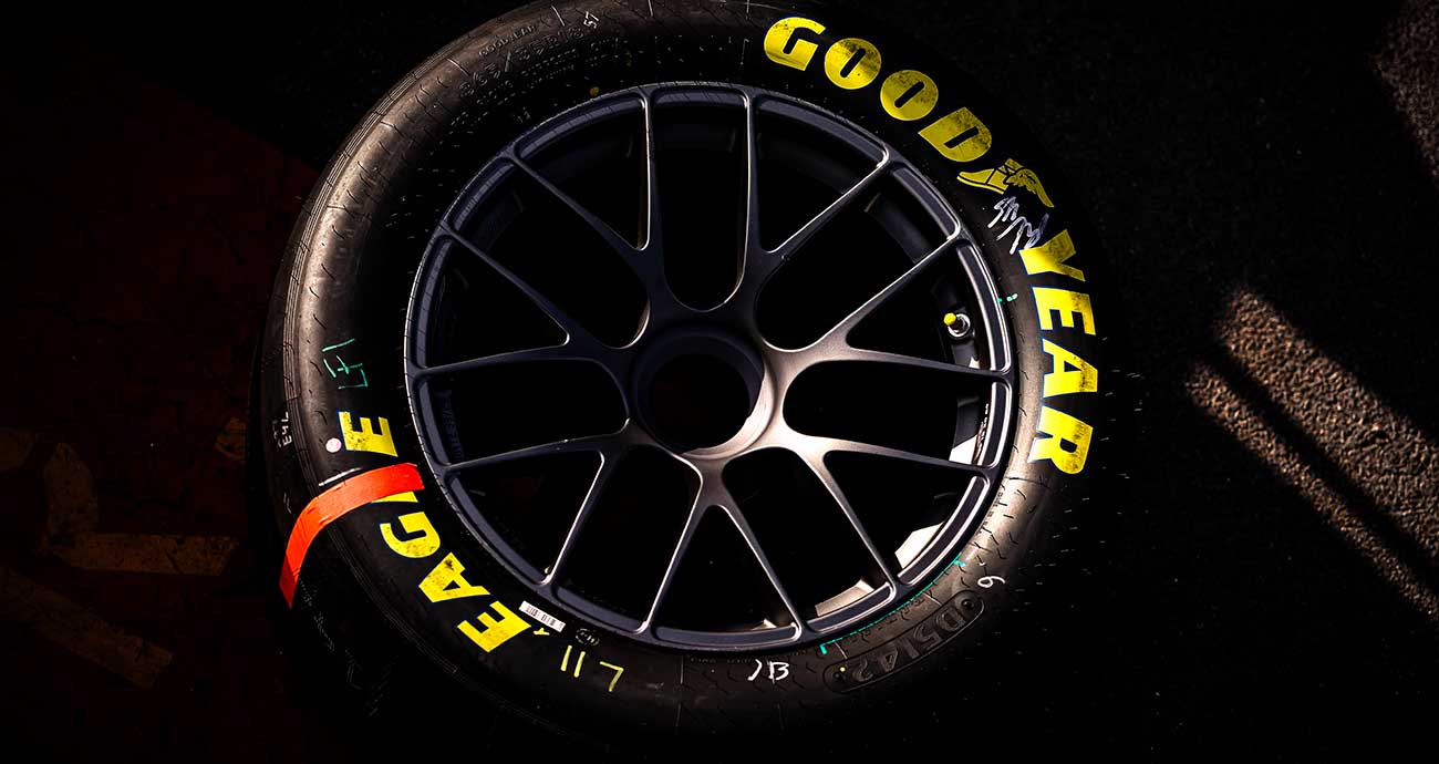 A Goodyear Racing tire for the Cup Series in the shadows on pit road
