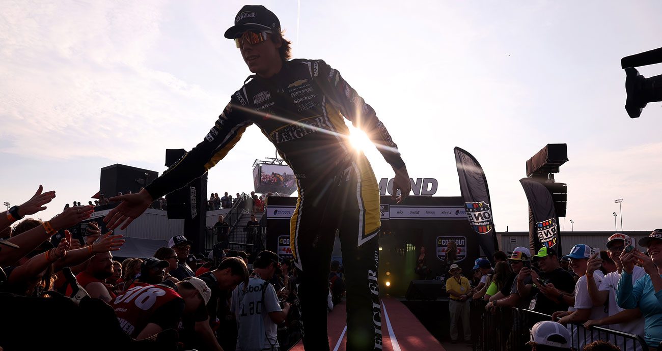 Carson Hocevar high-fives fans during NASCAR Cup Series driver introductions.