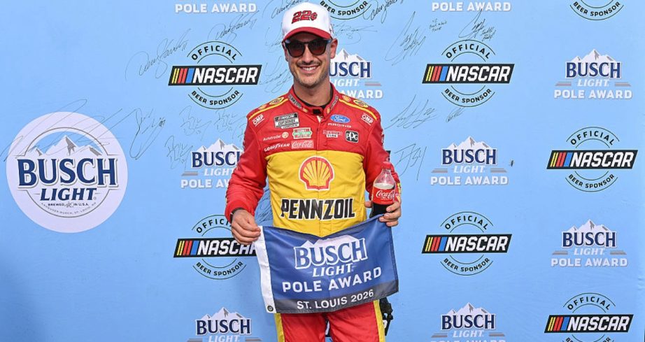 Joey Logano celebrates after winning the pole at Gateway.