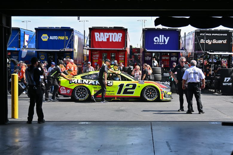 Team penske team pushes car to the grid.
